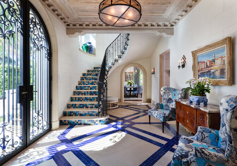 Mediterranean foyer in Miami with a double front door, a glass front door and multi-coloured floors.
