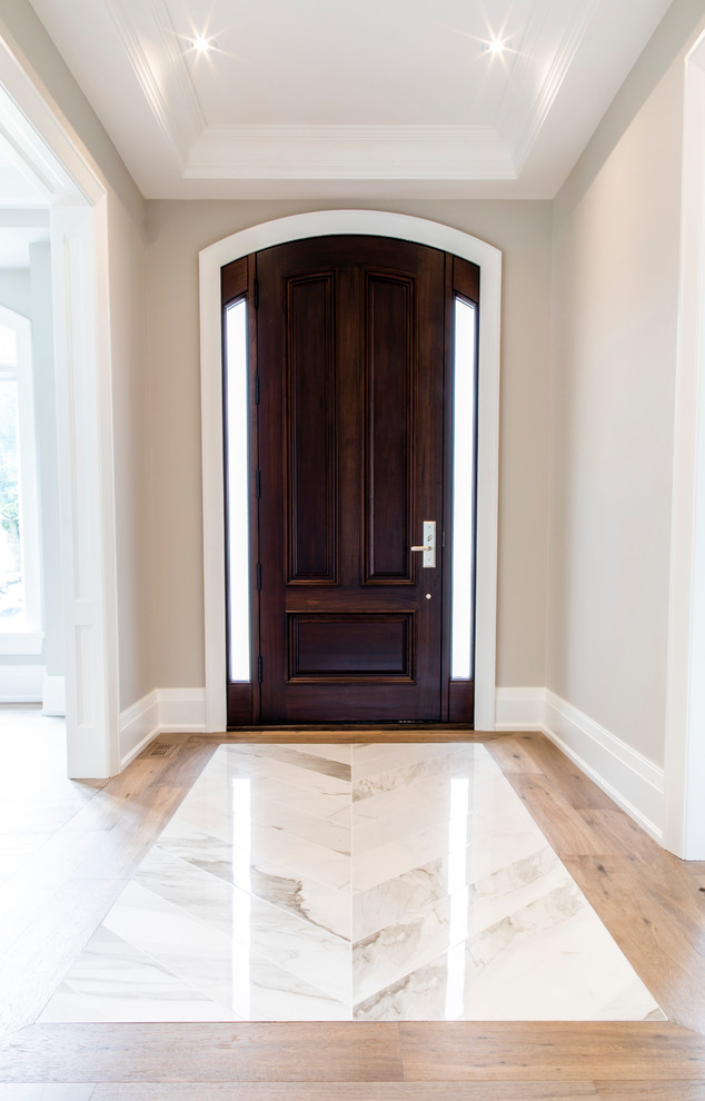 Mid-sized transitional light wood floor and brown floor entryway photo in Toronto with beige walls and a dark wood front door