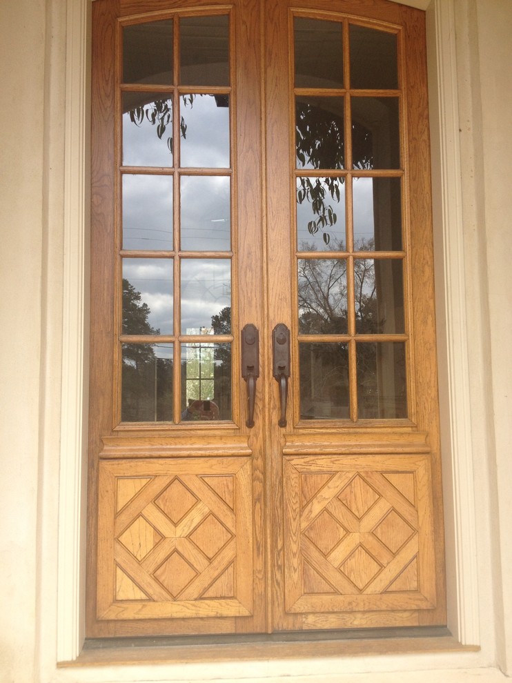 Réalisation d'une porte d'entrée tradition avec une porte double et une porte en bois clair.