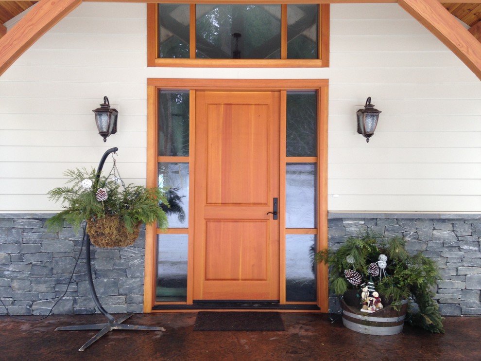 Example of a large trendy entryway design in Vancouver with a medium wood front door