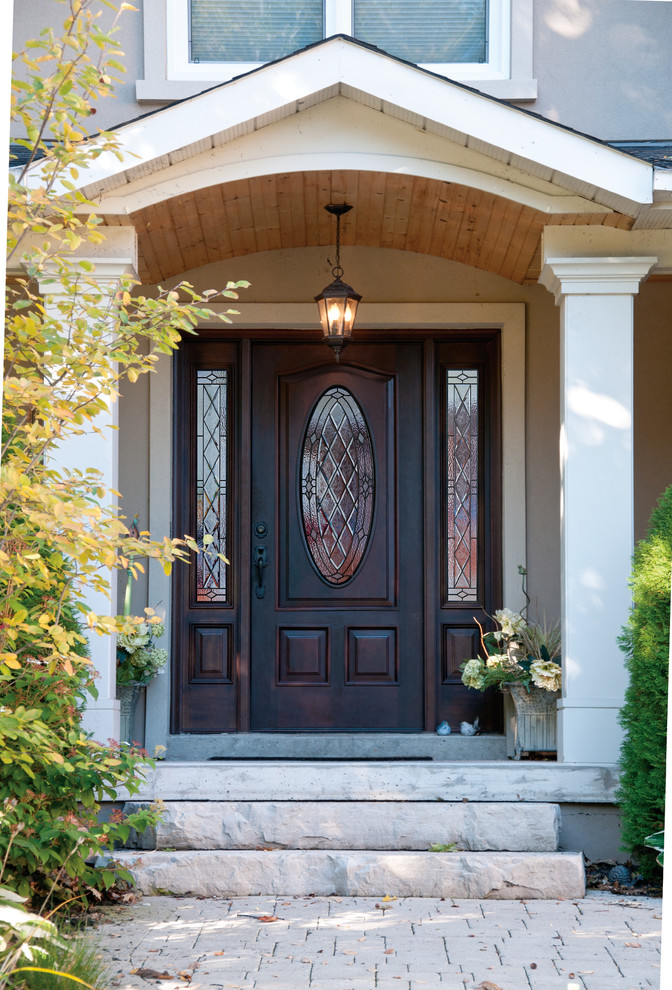 Inspiration for a medium sized traditional front door in Vancouver with a single front door and a dark wood front door.