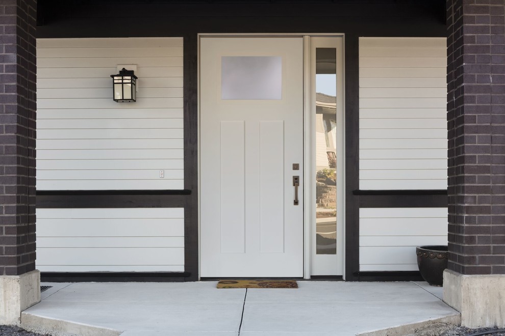 Photo of a medium sized contemporary front door in Vancouver with a single front door and a white front door.