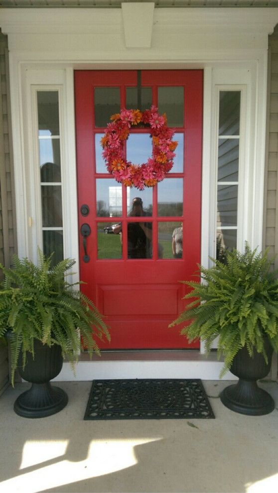 Esempio di una porta d'ingresso chic di medie dimensioni con una porta singola e una porta rossa