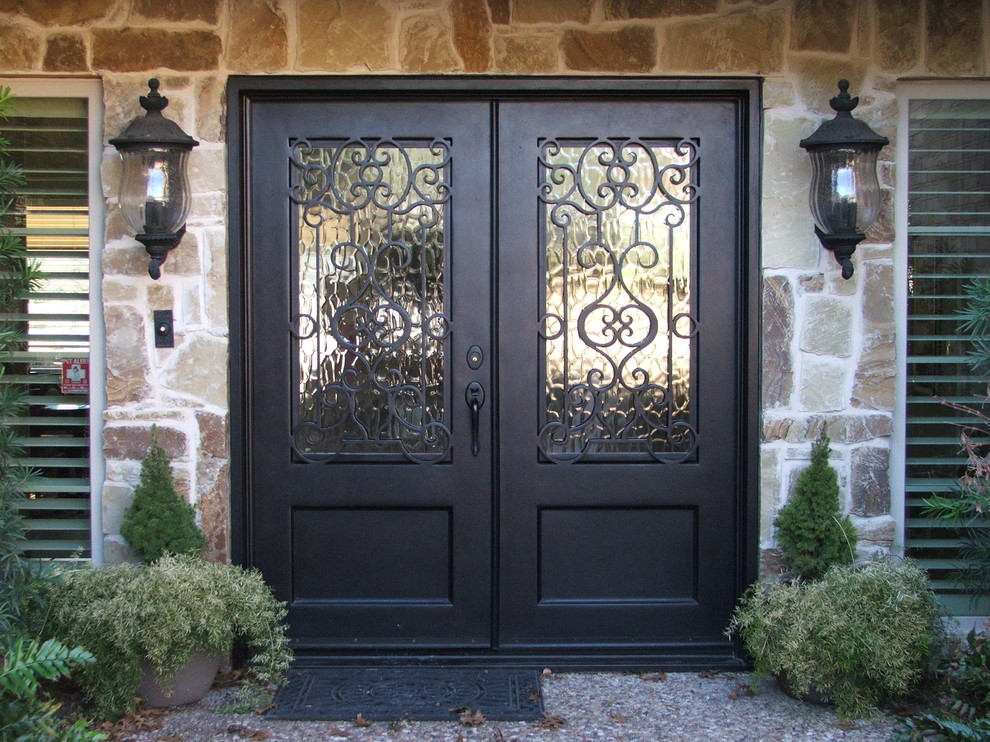 This is an example of a large traditional front door in Dallas with multi-coloured walls, a double front door and a brown front door.