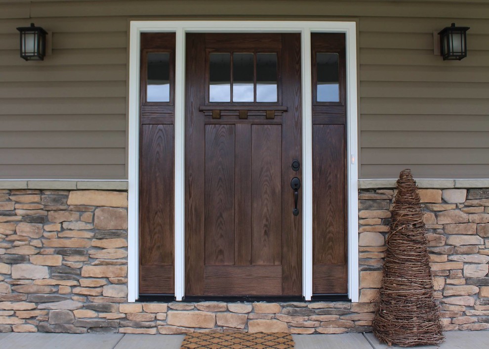 На фото: входная дверь в стиле кантри с одностворчатой входной дверью и входной дверью из темного дерева