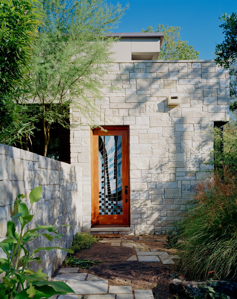 Example of a trendy front door design in Austin with a glass front door