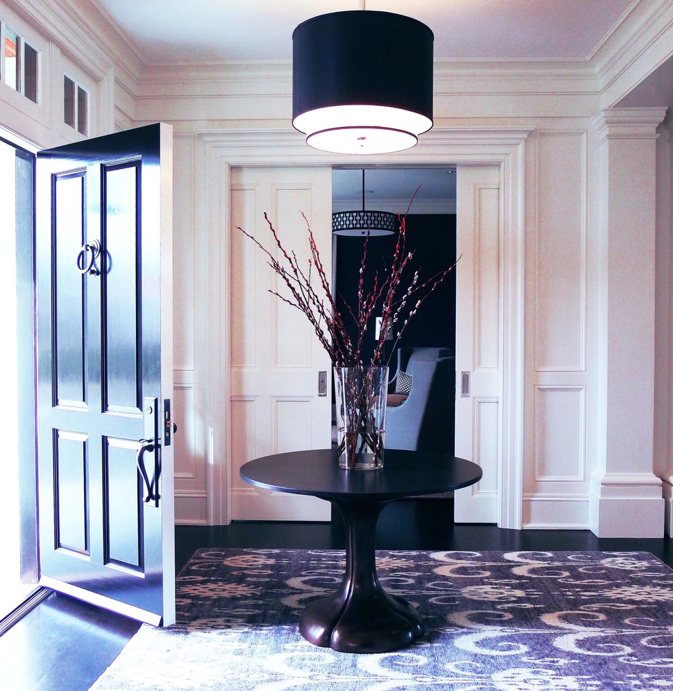 This is an example of a medium sized contemporary foyer in New York with white walls, cork flooring, a single front door and brown floors.