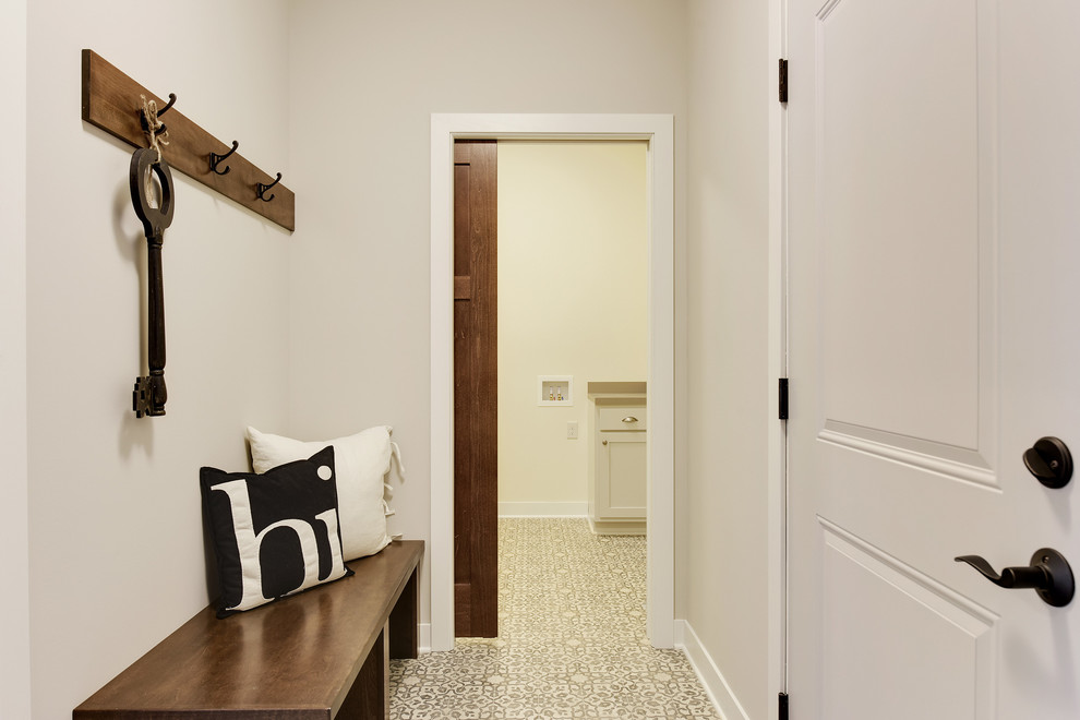 На фото: тамбур среднего размера в стиле неоклассика (современная классика) с серыми стенами, полом из керамической плитки, одностворчатой входной дверью, белой входной дверью и разноцветным полом