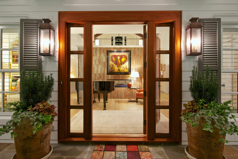 This is an example of a large classic front door in Raleigh with a single front door, a medium wood front door and feature lighting.