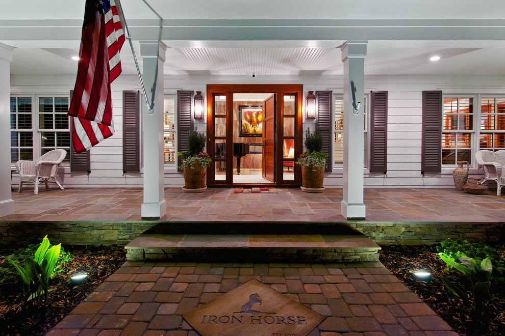 This is an example of a large traditional entrance in Raleigh with a single front door, a medium wood front door, white walls, slate flooring and multi-coloured floors.