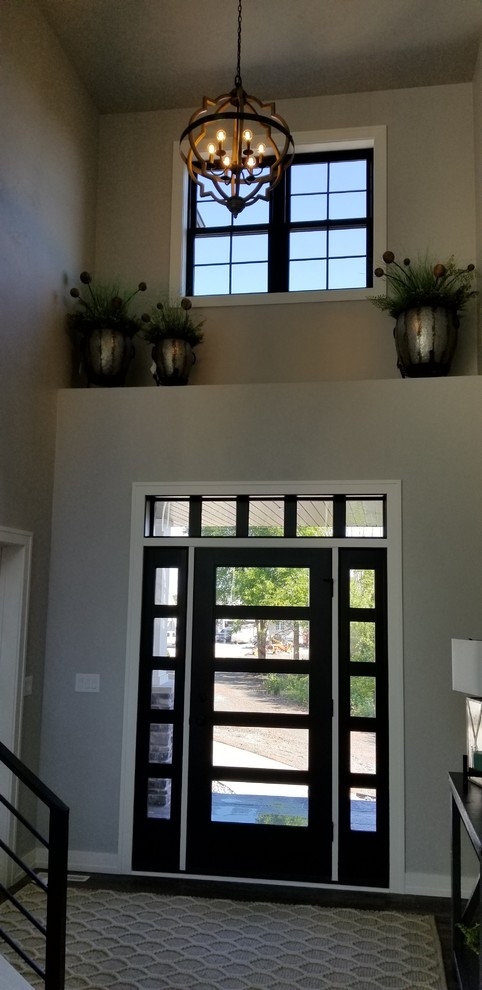 Inspiration for a large traditional foyer in Milwaukee with grey walls, a single front door and a black front door.