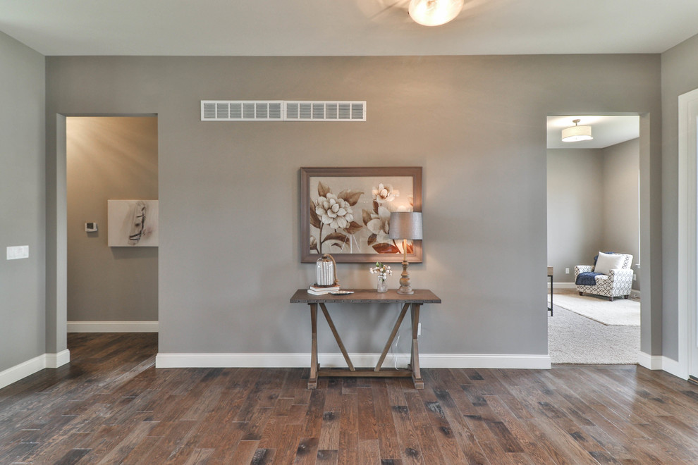 Entryway - mid-sized transitional dark wood floor and brown floor entryway idea in St Louis with gray walls and a white front door