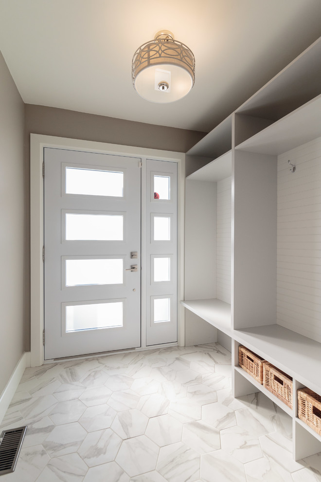Mid-sized transitional ceramic tile and white floor entryway photo in Montreal with beige walls and a white front door