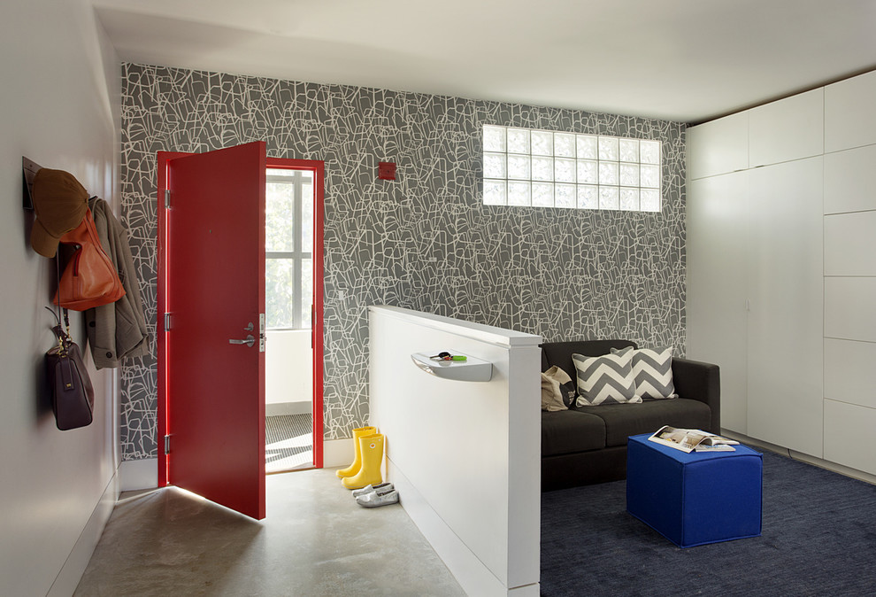 Inspiration for a mid-sized contemporary concrete floor entryway remodel in Boston with multicolored walls and a red front door