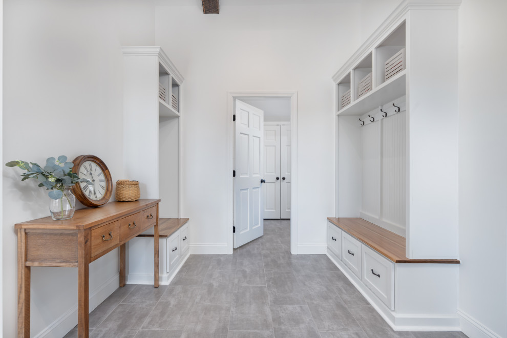 Mid-sized country porcelain tile and gray floor entryway photo in Boston with gray walls and a white front door