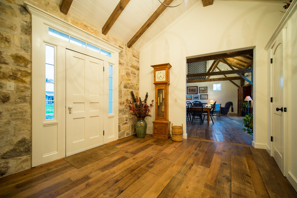 This is an example of a large rural foyer in Other with white walls.