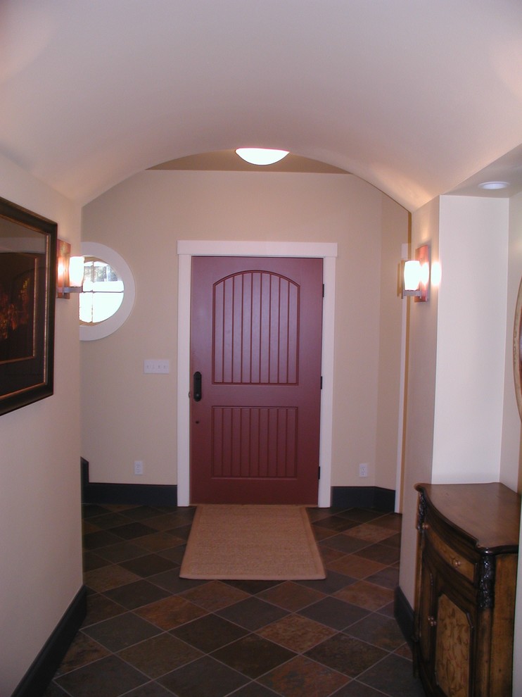 Ispirazione per un corridoio country di medie dimensioni con pareti beige, pavimento con piastrelle in ceramica, una porta singola, una porta rossa e pavimento multicolore