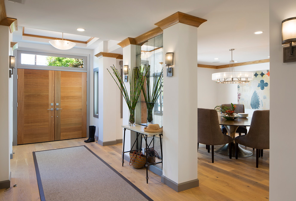 Example of a mid-sized transitional entryway design in San Francisco with a light wood front door