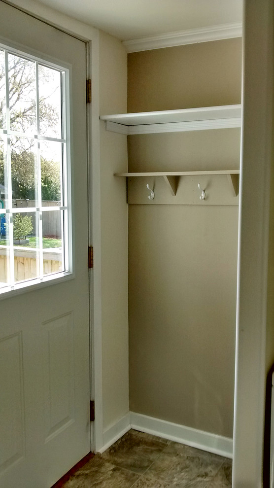 This is an example of a small traditional entrance in Other with beige walls, lino flooring and a white front door.