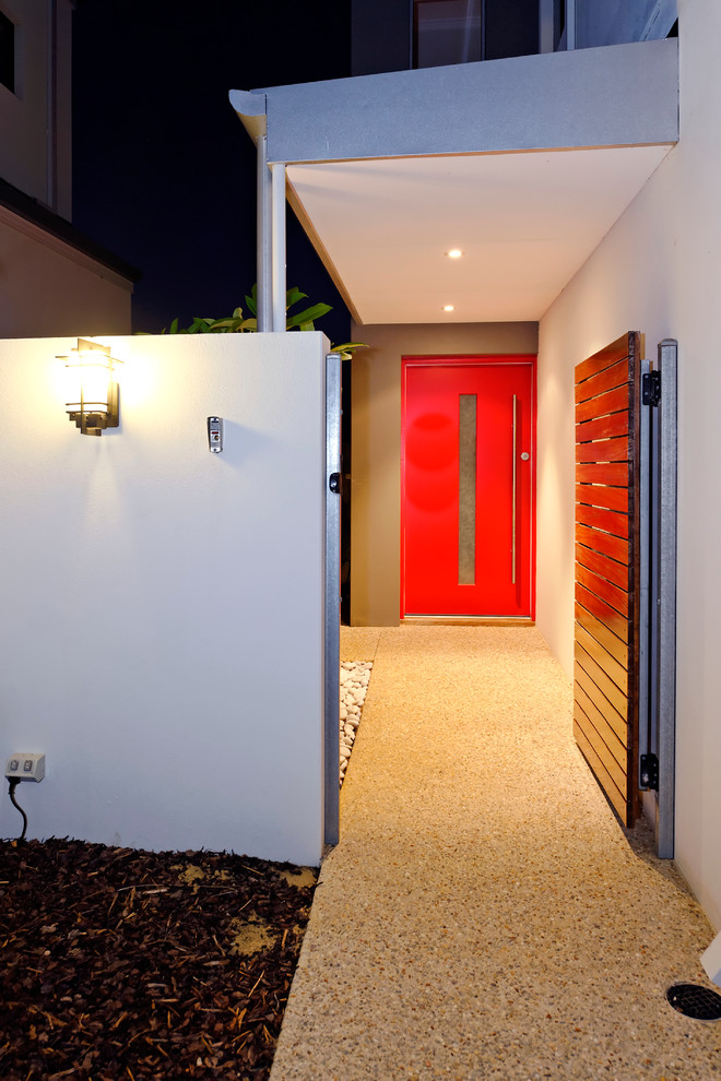 Idéer för en mellanstor modern ingång och ytterdörr, med vita väggar, betonggolv, en pivotdörr och en röd dörr