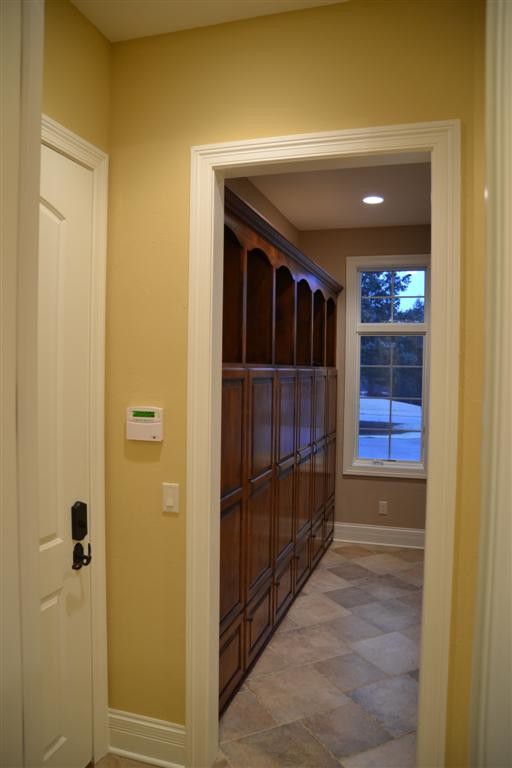 Design ideas for a large traditional boot room in Milwaukee with yellow walls, porcelain flooring, a single front door, a white front door and beige floors.