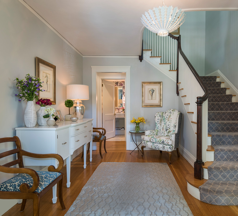 Example of a beach style medium tone wood floor foyer design in Providence with gray walls