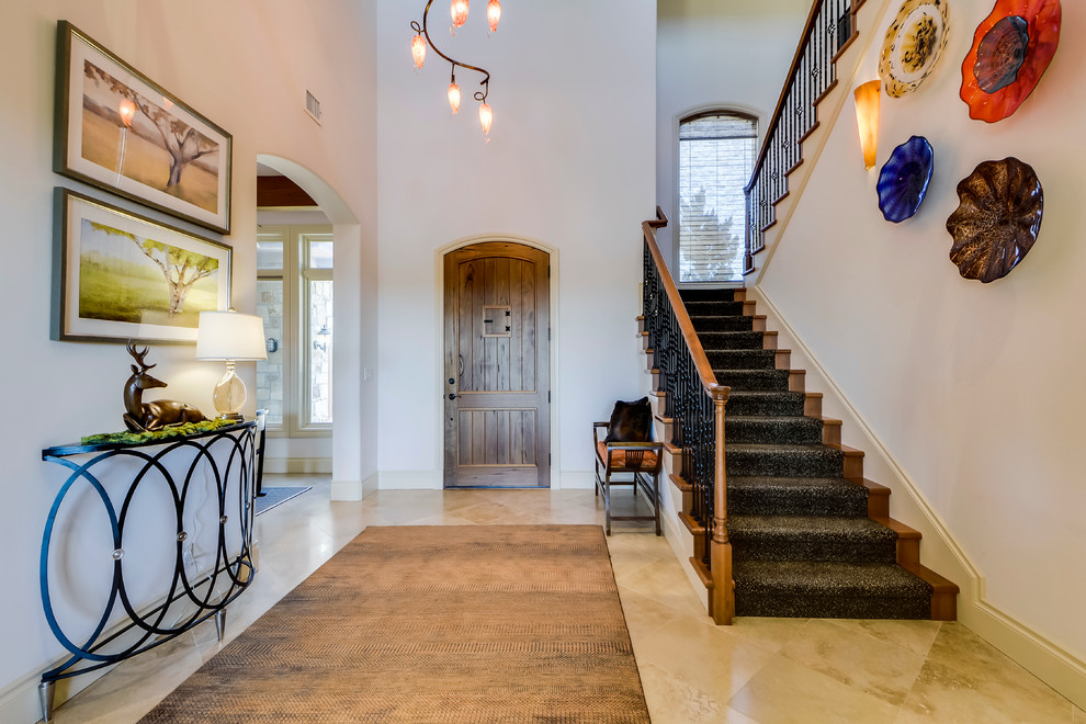Mid-sized transitional travertine floor entryway photo in Austin with white walls and a medium wood front door