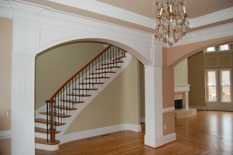 This is an example of a medium sized classic foyer in Houston with brown walls and medium hardwood flooring.