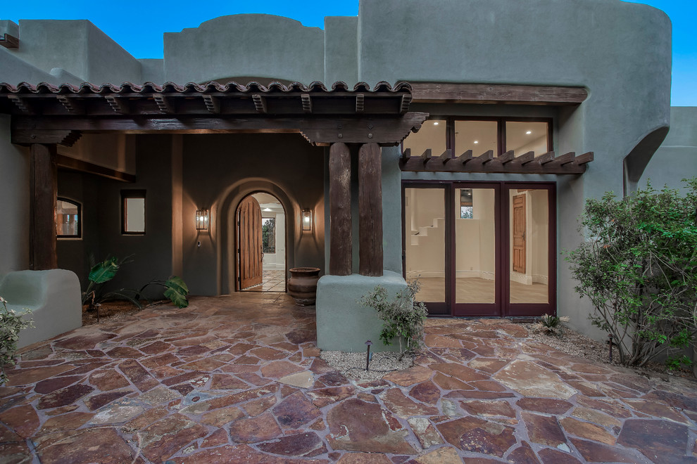 Mid-sized southwest entryway photo in Phoenix with gray walls and a medium wood front door
