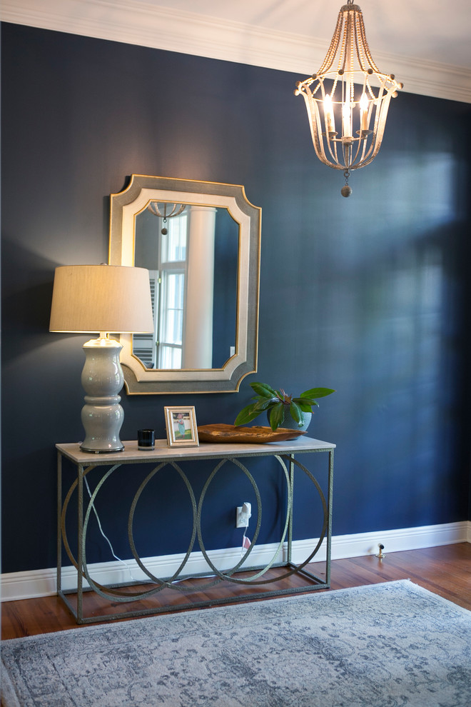 Photo of a small classic foyer in Cleveland with blue walls, medium hardwood flooring, a dark wood front door, a double front door and brown floors.