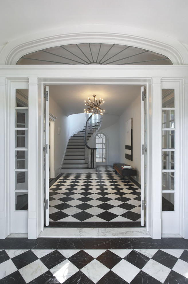 Immagine di una porta d'ingresso contemporanea di medie dimensioni con pareti bianche, pavimento in marmo, una porta a due ante, una porta bianca e pavimento multicolore