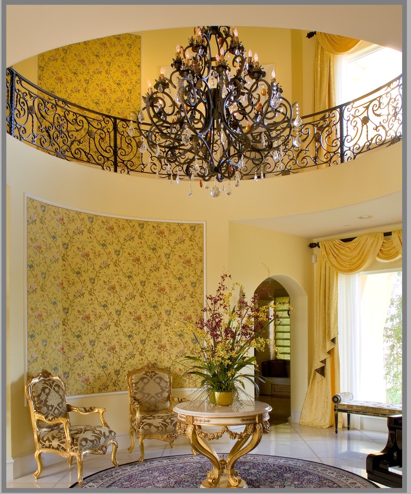 Example of a large classic foyer design in Los Angeles with yellow walls