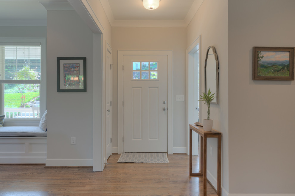 Mid-sized arts and crafts light wood floor entryway photo in Other with a white front door and white walls