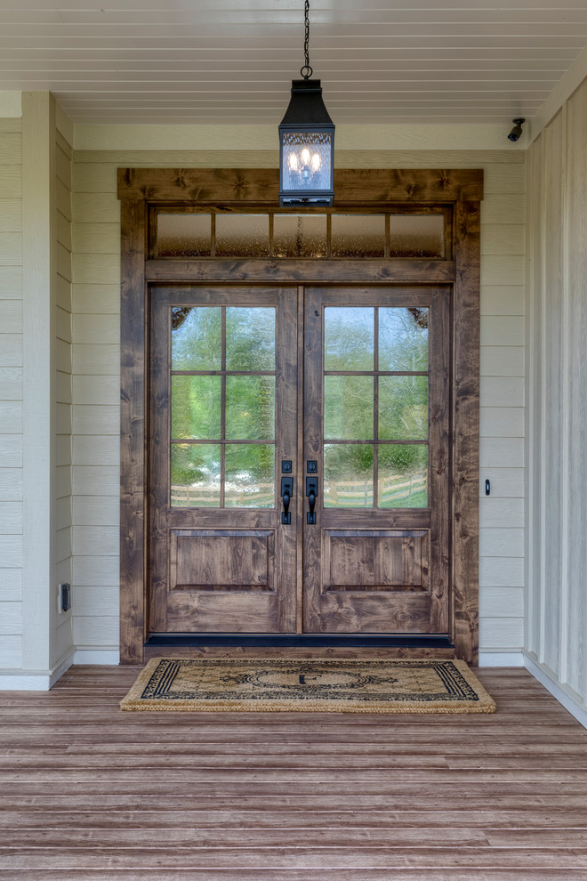 Inspiration for an expansive farmhouse front door in Other with beige walls, medium hardwood flooring, a double front door, a medium wood front door and brown floors.