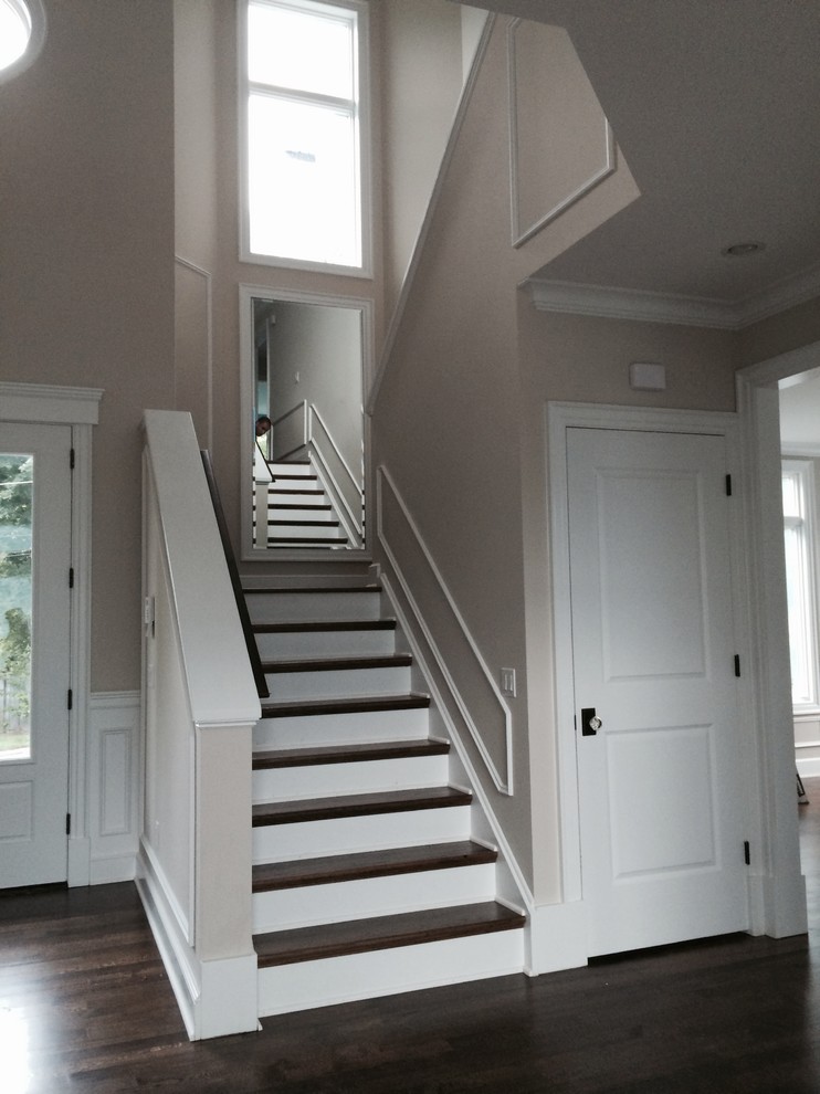 Photo of a contemporary foyer in New York with beige walls, dark hardwood flooring, a double front door and a white front door.