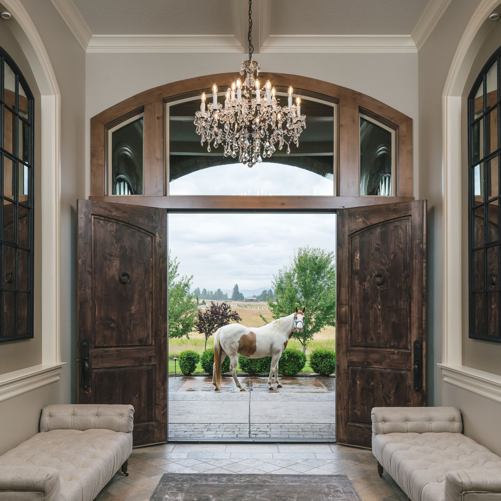 Example of a large classic travertine floor, beige floor and coffered ceiling entryway design in Portland with gray walls and a dark wood front door