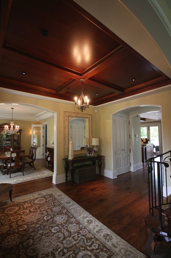 This is an example of a large classic foyer in Vancouver with beige walls, medium hardwood flooring, a single front door and a medium wood front door.