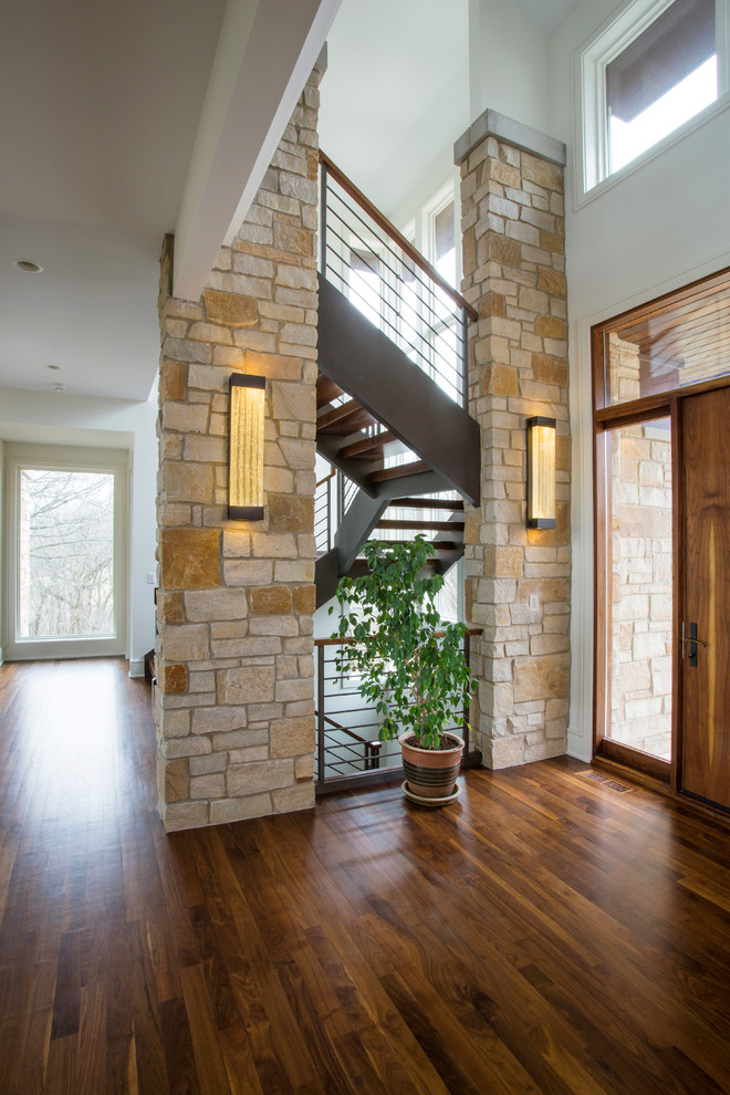 Example of a large transitional dark wood floor entryway design in Chicago with white walls and a medium wood front door