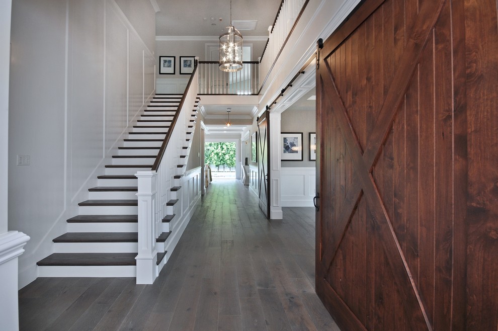 Medium sized country foyer in Detroit with white walls, dark hardwood flooring and brown floors.