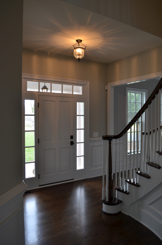 Example of a mid-sized classic dark wood floor entryway design in Wilmington with gray walls and a white front door