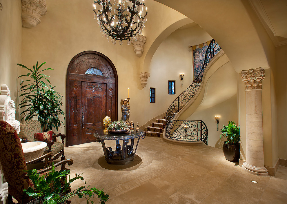 Tuscan entryway photo in Phoenix with beige walls and a dark wood front door