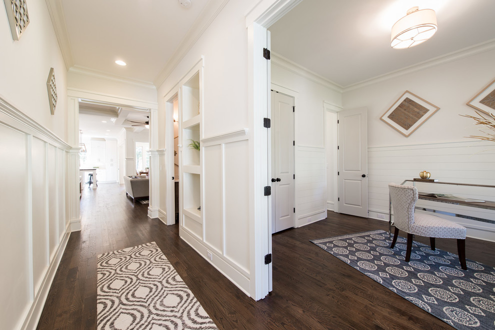 Ispirazione per un ingresso tradizionale di medie dimensioni con pareti bianche, pavimento in legno massello medio e pavimento marrone