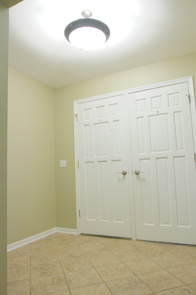 This is an example of a small classic foyer in Omaha with beige walls, ceramic flooring, a double front door and a white front door.