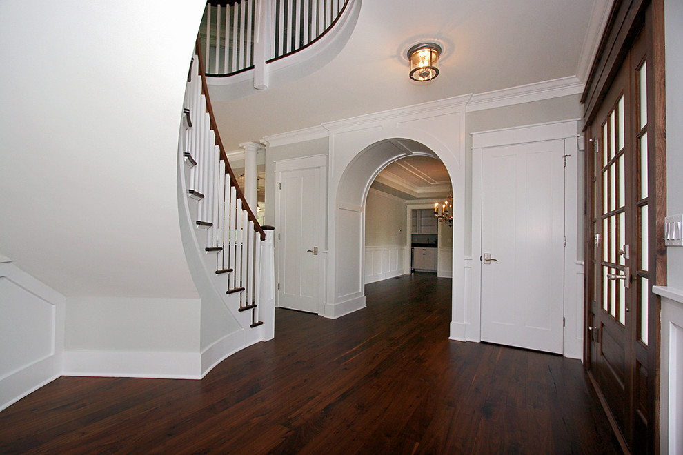 Inspiration for a timeless dark wood floor entryway remodel in New York with a dark wood front door and gray walls