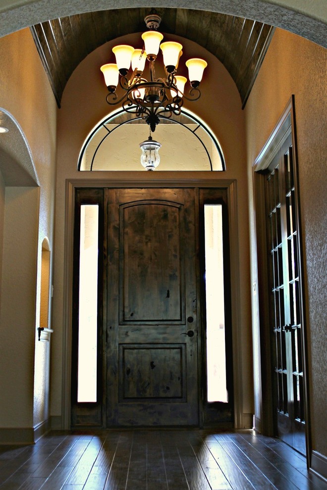 Esempio di un grande ingresso stile rurale con pareti beige, parquet scuro, una porta singola, una porta in legno scuro e pavimento marrone