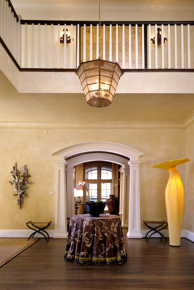 This is an example of a traditional foyer in DC Metro with beige walls and dark hardwood flooring.