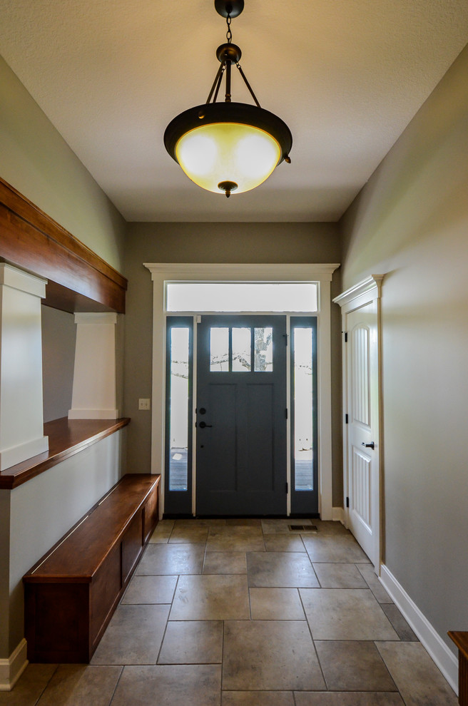 На фото: входная дверь среднего размера в стиле кантри с серыми стенами, полом из керамической плитки, одностворчатой входной дверью и синей входной дверью с