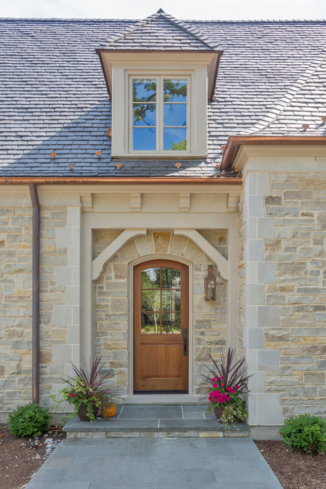 French country slate floor entryway photo in Chicago with beige walls and a medium wood front door