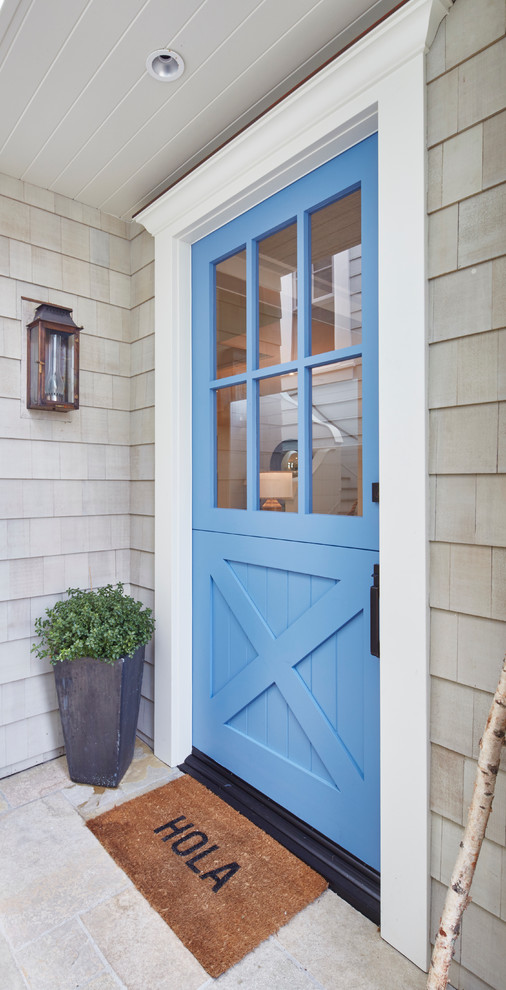 Inspiration for a farmhouse entrance in Los Angeles with a single front door, a blue front door and feature lighting.