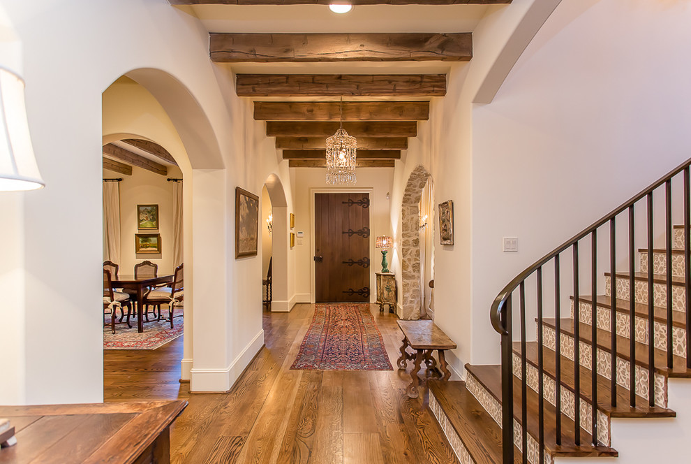 This is an example of a medium sized mediterranean entrance in Houston with beige walls and medium hardwood flooring.